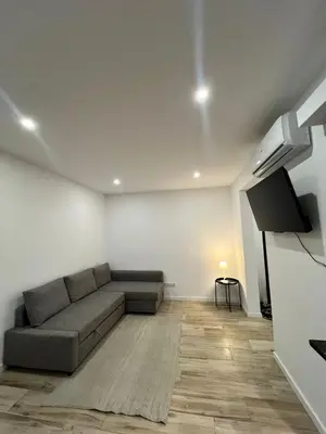 a living room with a couch and a flat screen tv at O&P Apartments in Faro