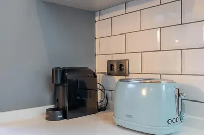 a kitchen counter with a coffee maker and a toaster at The Warehouse - Industrial Loft in Faro