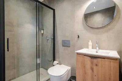 a bathroom with a shower and a toilet and a sink at The Warehouse - Industrial Loft in Faro
