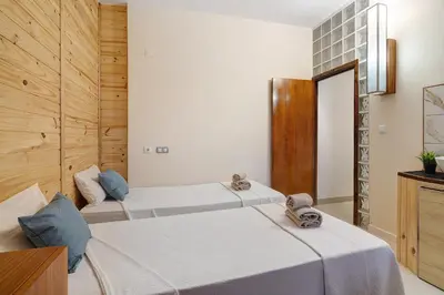 a hotel room with two beds with white sheets at Paraiso do Atlantico in Albufeira
