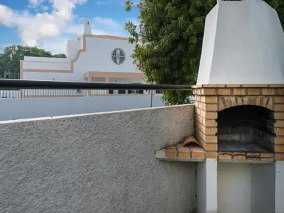 a brick oven on a wall in front of a building at Akivillas Quarteira Cool in Quarteira