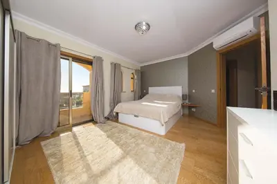 a bedroom with a bed and a large window at ABF38, encantadora Villa V4 em lugar sossegado in Guia