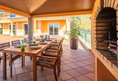 a wooden table and chairs on a patio at Villa Sierra in Guia
