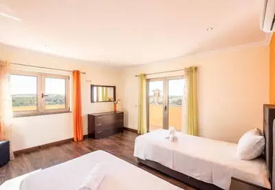 a hotel room with two beds and a window at Villa Sierra in Guia