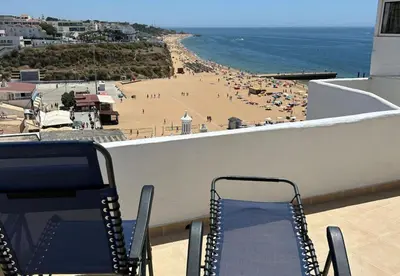 a view of a beach from a balcony at Playa Vista guest house in Albufeira