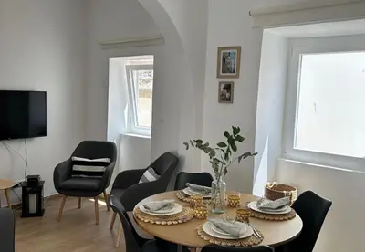 a living room with a table and chairs at Playa Vista guest house in Albufeira