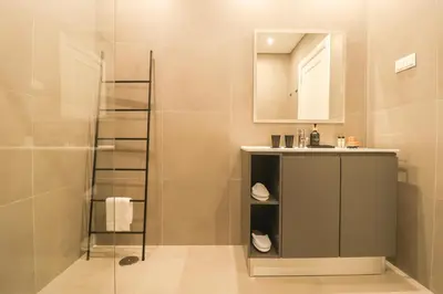 a kitchen with white cabinets and a window at Faro Old Town Apartments in Faro
