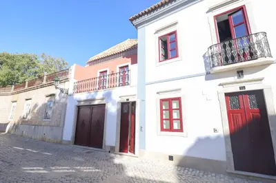 a red door with a staircase in a room at Faro Old Town Apartments in Faro
