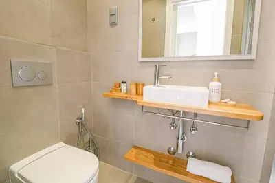 a bathroom with a toilet and a sink and a mirror at Faro Old Town Apartments in Faro