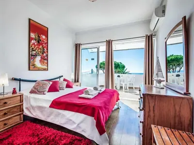 a bedroom with a large bed with a red blanket at Holiday Home Chalet Villa Oceano mit privatem Pool by Interhome in Albufeira