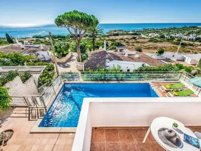 a villa with a swimming pool and the ocean at Holiday Home Chalet Villa Oceano mit privatem Pool by Interhome in Albufeira