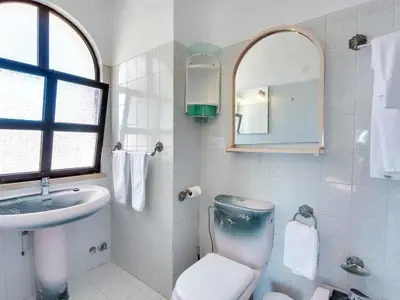 a bathroom with a toilet and a sink and a mirror at Holiday Home Chalet Villa Albuar mit eigenem Pool by Interhome in Albufeira
