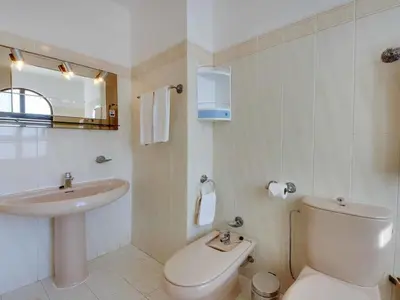 a bathroom with a toilet and a sink at Holiday Home Chalet Villa Albuar mit eigenem Pool by Interhome in Albufeira