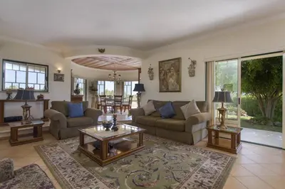 a living room with two couches and a table at Villa Anthony by Villa Plus in Terras Novas