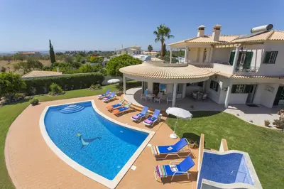 a swimming pool in the backyard of a house at Villa Anthony by Villa Plus in Terras Novas