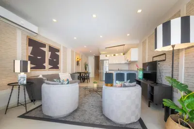 a living room with two couches and a kitchen at Casa do Gil, Vale do Lobo Beach and Golf in Loulé