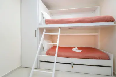 a room with two bunk beds in it at Casa do Gil, Vale do Lobo Beach and Golf in Loulé