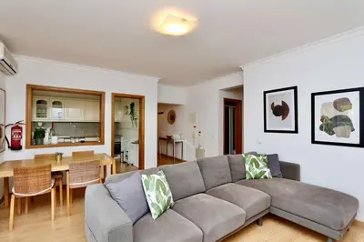 a living room with a couch and a table at Melias apartment - Cleverdetails, Vilamoura in Vilamoura