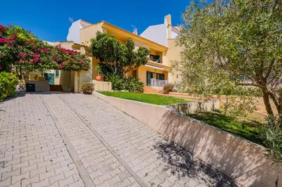 a house with a cobblestone street in front of it at Villa Carela in Albufeira