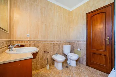 a bathroom with a toilet and a sink at Villa Carela in Albufeira