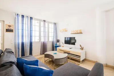 a living room with a couch and a tv at Margarida Apartment - Ping pong table in Albufeira