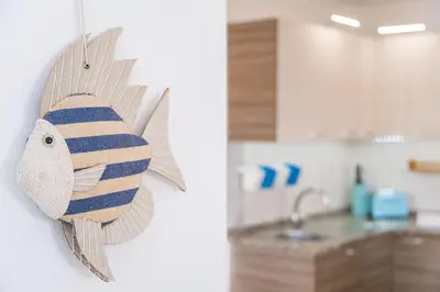 a fish decoration on the wall of a kitchen at Margarida Apartment - Ping pong table in Albufeira