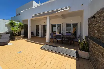 a house with a patio with a table and chairs at Casa Jokpa Mar Near So Rafael Beach in Albufeira