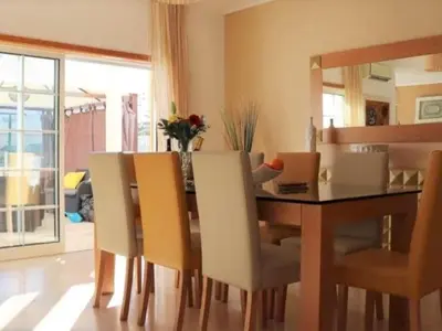 a dining room with a table and chairs at Vila Girassol by Stay ici Algarve Holiday Rental in Albufeira