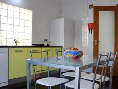 a kitchen with a table with a bowl of fruit on it at Vila Girassol by Stay ici Algarve Holiday Rental in Albufeira