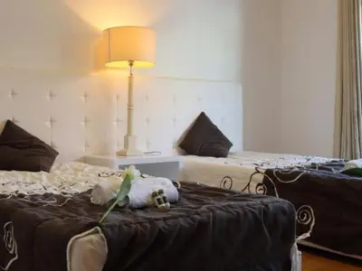 a room with two beds with a stuffed animal on the bed at Vila Girassol by Stay ici Algarve Holiday Rental in Albufeira