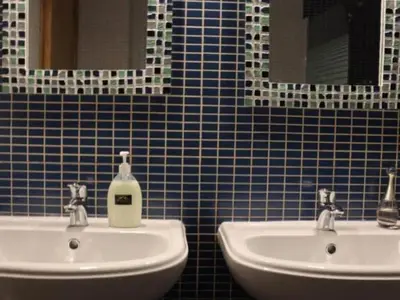 a bathroom with two sinks and two mirrors at Vila Girassol by Stay ici Algarve Holiday Rental in Albufeira