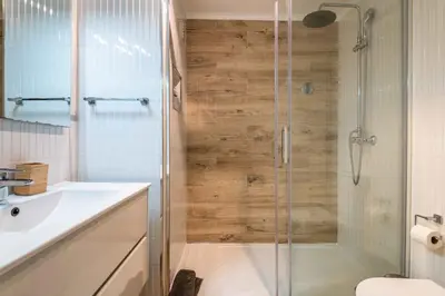 a bathroom with a shower with a toilet and a sink at Rocco del Mar by Portucasa in Albufeira