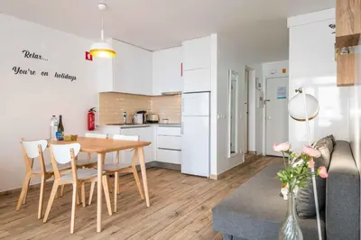 a kitchen and dining room with a table and chairs at Rocco del Mar by Portucasa in Albufeira