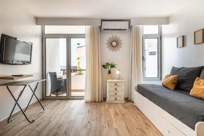 a bedroom with a bed and a desk and a television at Rocco del Mar by Portucasa in Albufeira