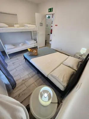 a room with a bed and a table with a hat on it at Blife Delya private rooms at Faro beach in Faro