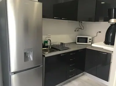 a kitchen with a stainless steel refrigerator and a sink at Blife Delya private rooms at Faro beach in Faro