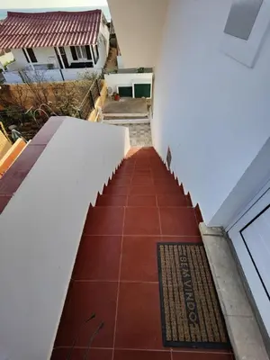 a stairway with a red tile floor in a building at Blife Petrya private rooms at Faro beach in Faro