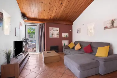 a living room with a couch and a tv at Lotus Villa, Albufeira in Albufeira
