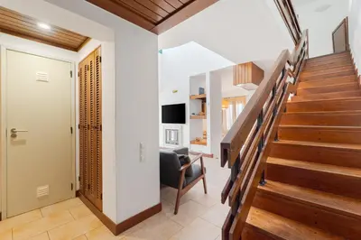 a staircase in a home with wooden floors at Villa Navegante com Piscina Privada em Vilamoura in Quarteira