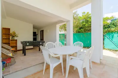 a barbecue grill in a backyard with a pool at Villa Navegante com Piscina Privada em Vilamoura in Quarteira