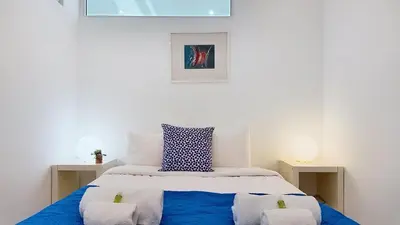 a blue and white bed with two pillows on it at Vilamar T0 in Vilamoura