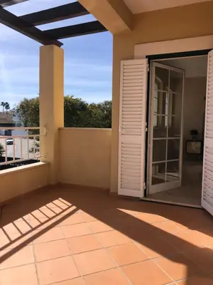 a patio with doors open to a balcony at Villa Sun & Shine in Faro