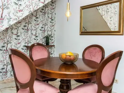 a dining room with a wooden table and pink chairs at Algarve Sun by Stay ici - Algarve Holiday Rental in Albufeira