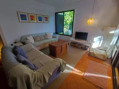 a living room with a couch and a tv at T2 Apartment with private garden in the Balaia Apartments, Albufeira, Algarve in Atalaia