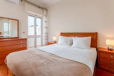 a bedroom with a large bed and a window at Cosy 2Bdr Flat in Faro Downtown by LovelyStay in Faro