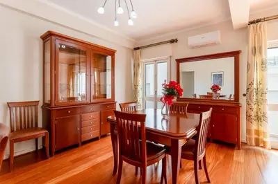 a dining room with a table and chairs and a mirror at Cosy 2Bdr Flat in Faro Downtown by LovelyStay in Faro