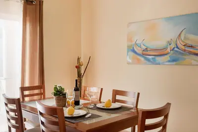 a bedroom with two beds and a window at Central Albufeira Stay | Balcony & AC in Albufeira