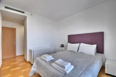 a bedroom with a bed with two towels on it at Vilamoura Aquamar in Quarteira