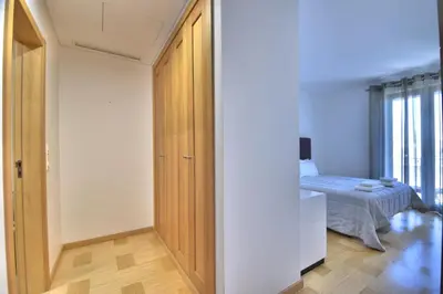 a bedroom with a closet and a bed in a room at Vilamoura Aquamar in Quarteira