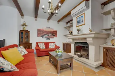 a bedroom with a bed and two night stands and a window at Villa das Buganvilias by Delilah Collection in Albufeira